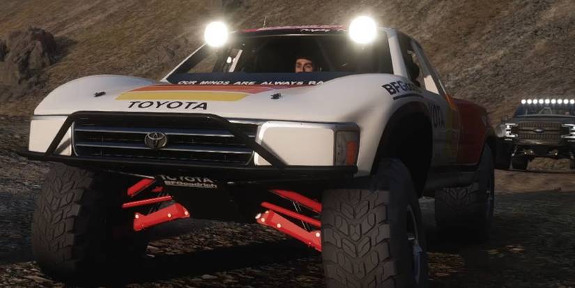 Forza Horizon 5 Toyota #1T100 Baja Truck head on driving through hilly terrain