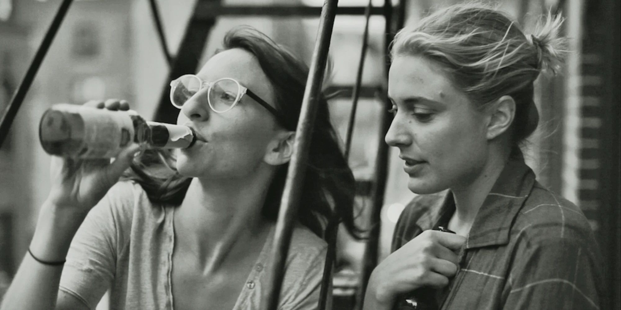 Frances and Sophie drinking on the fire escape in Frances Ha