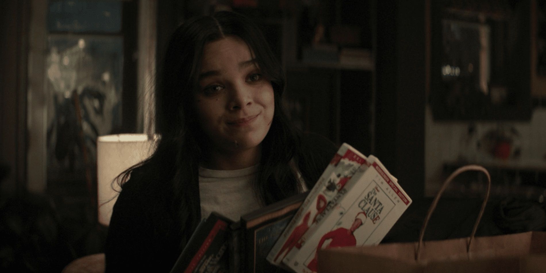 Hailee Steinfeld as Kate with Christmas movie DVDs in Hawkeye