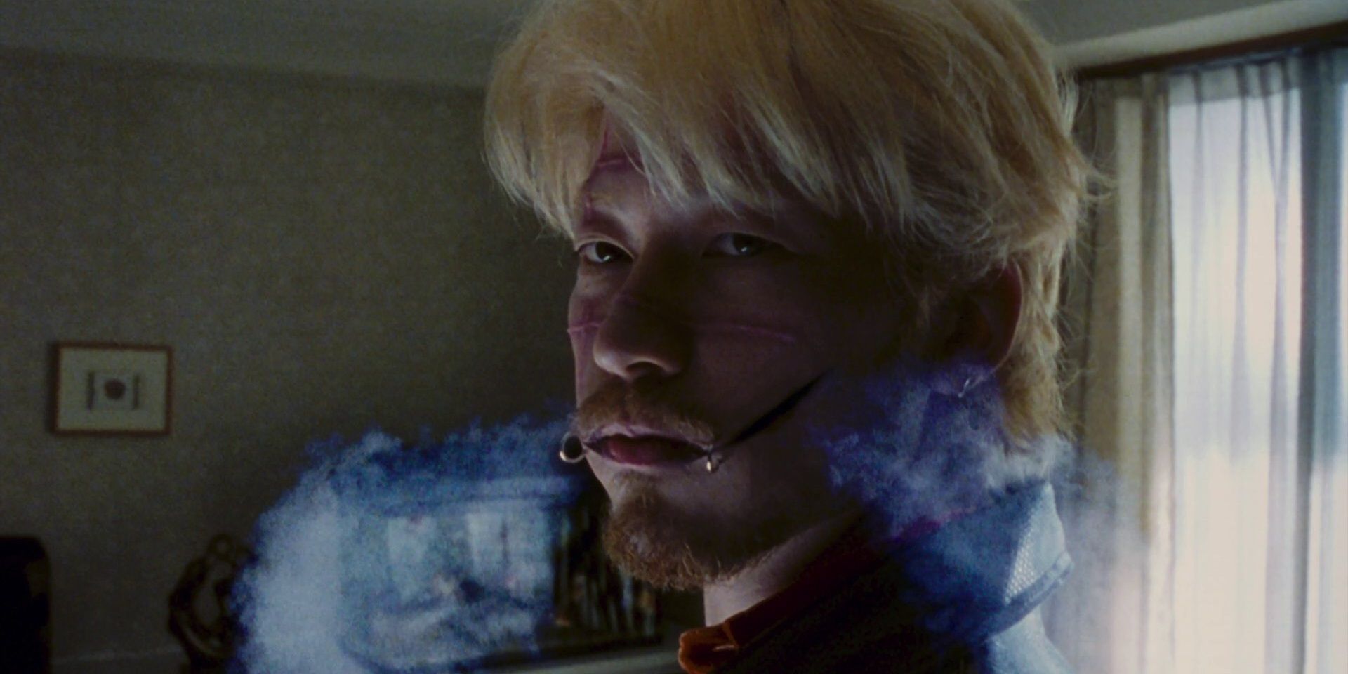 Kakihara blows smoke through his scars in Ichi the Killer