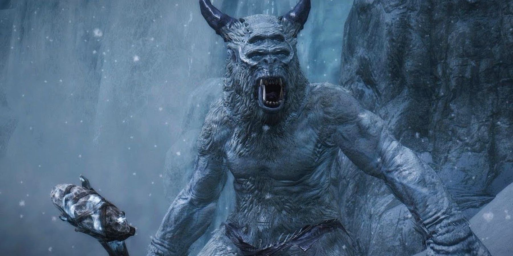 A frost giant roaring and holding a club in The Elder Scrolls 5: Skyrim