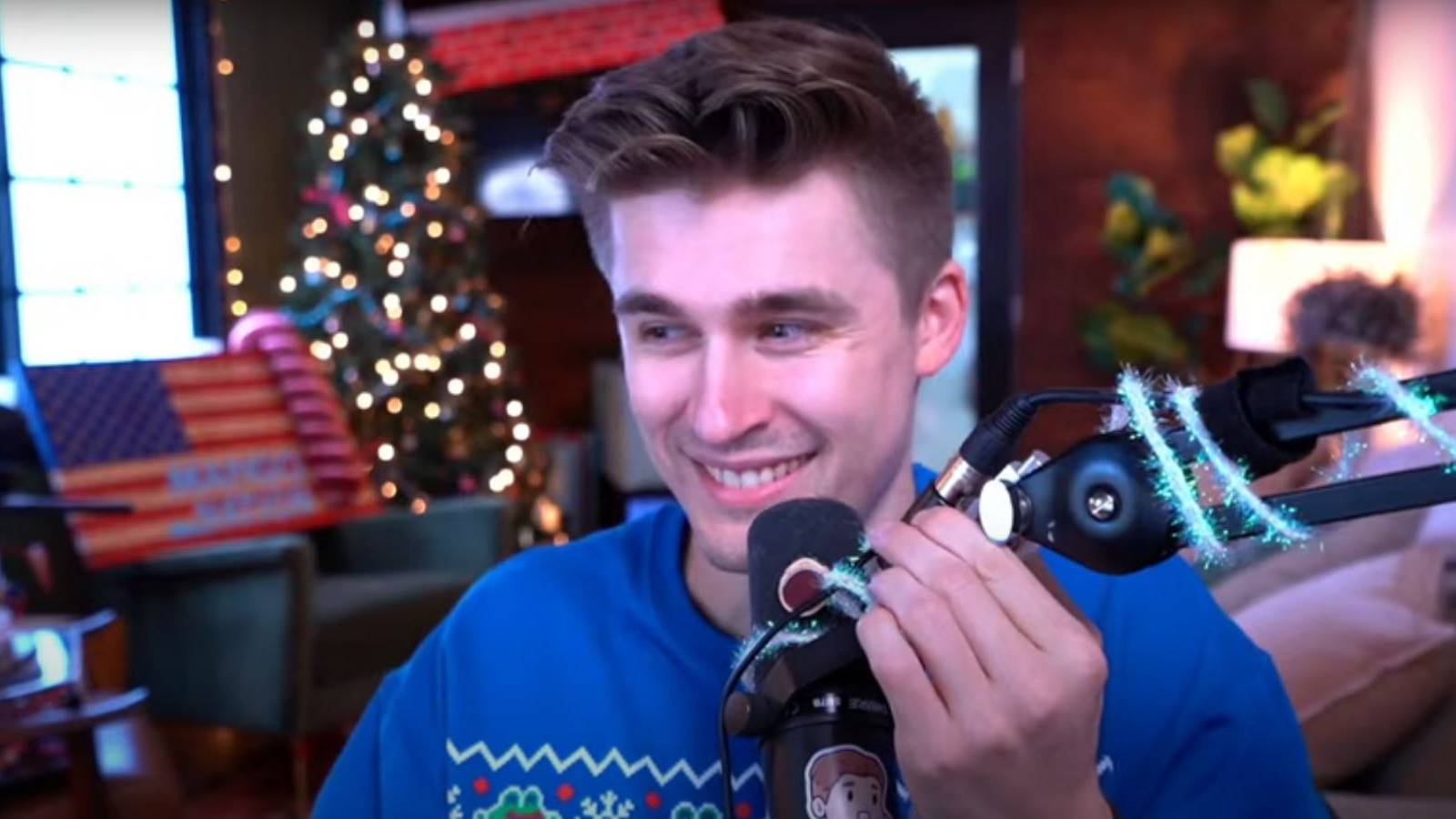 Ludwig Ahgren smiling and holding his microphone during a Twitch stream