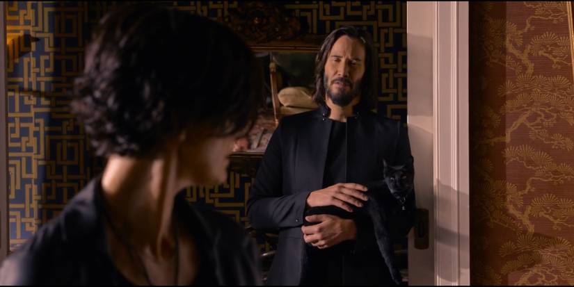 Neo holding Deja Vu the Cat in Matrix Resurrections