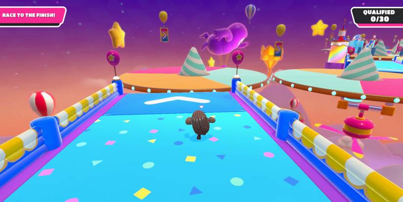 a fall guy in brown sack cloth runs toward an empty, colorful platform with a striped cone in the middle