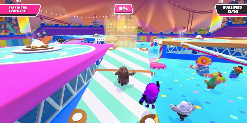 a fall guy bean running up a green and white striped ramp toward a golden spotlight 