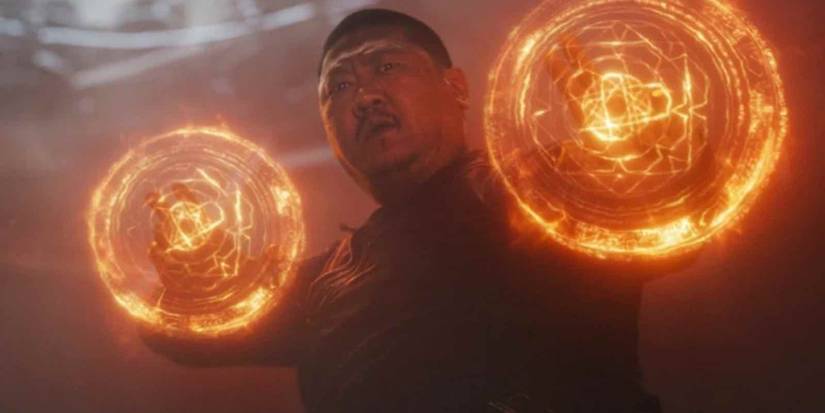 wong, a heavy-set Asian man with short-cropped hair and a mustache, holds magical wards over both his hands