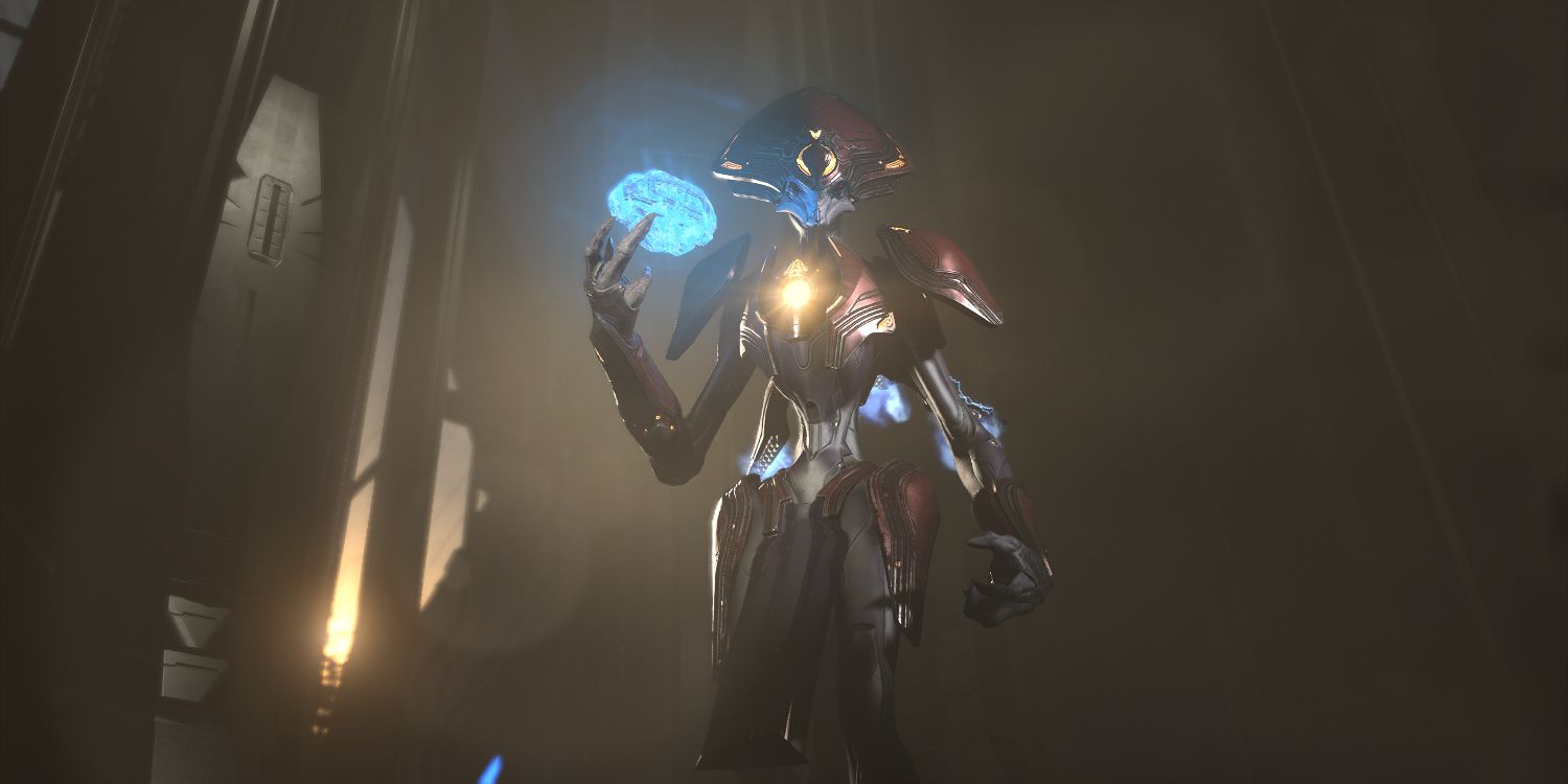 an alien being with a long, slender frame, gray skin, and a suit of metallic, futuristic armor holds a glowing blue object in one hand 