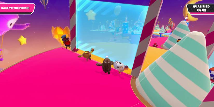 a fall guy bean in brown sack cloth runs toward a blue force field on a tipping platform