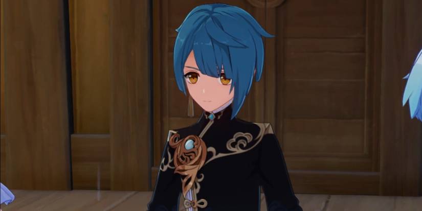 Xingqiu standing in front of a wooden house