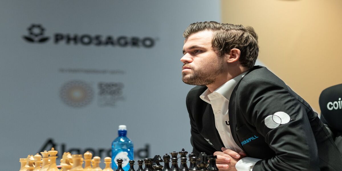 Carlsen looking over chess board