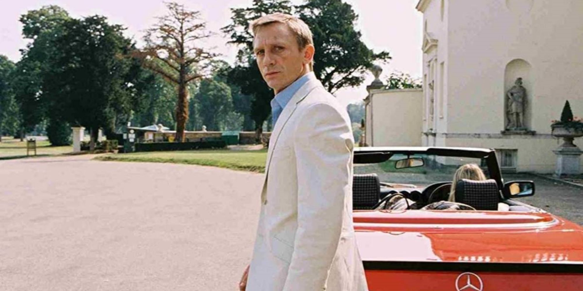 daniel craig in layer cake in front of a car
