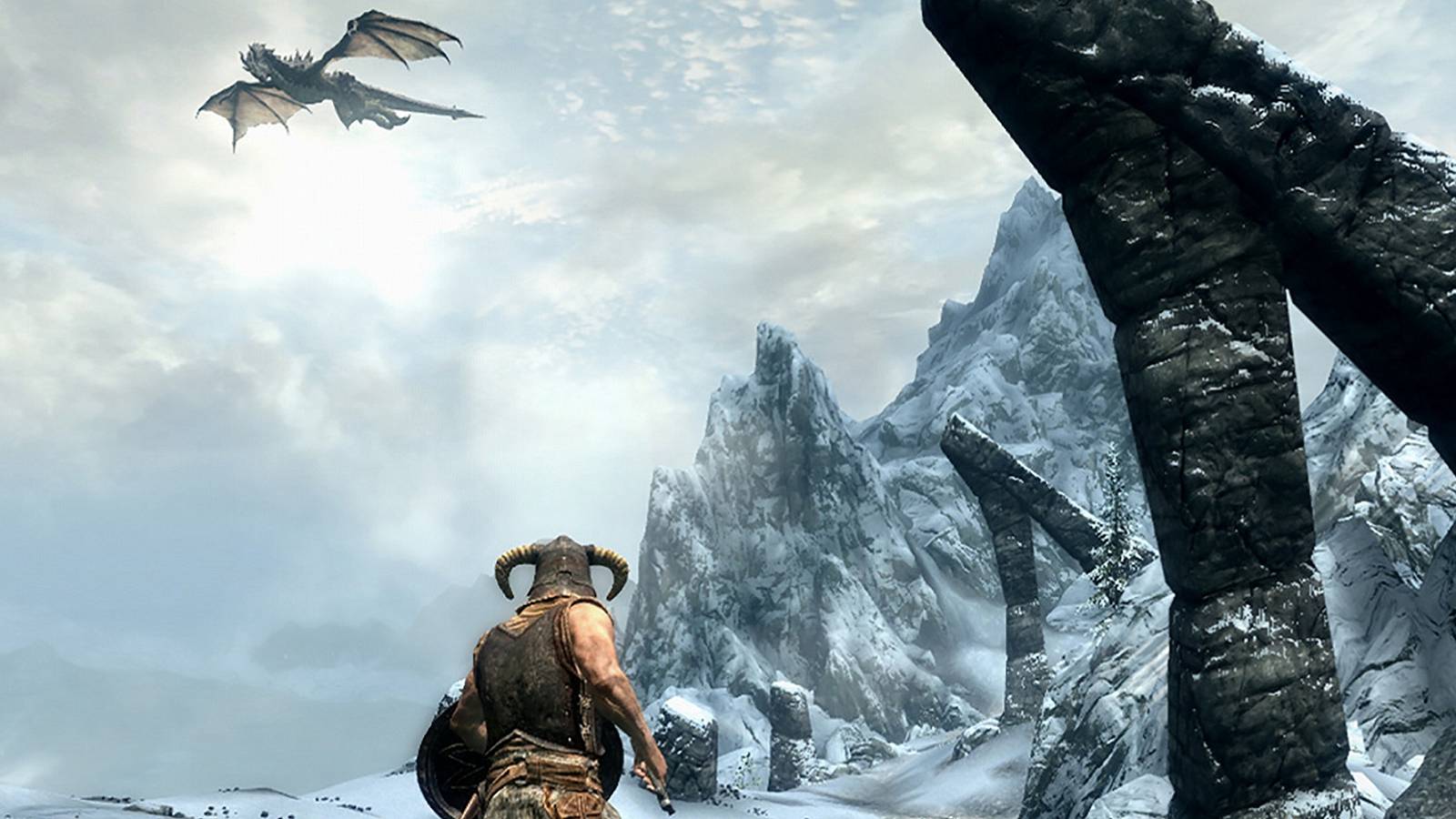 Screenshot from The Elder Scrolls 5: Skyrim showing the Dragonborn looking up at a dragon in the wintry sky.