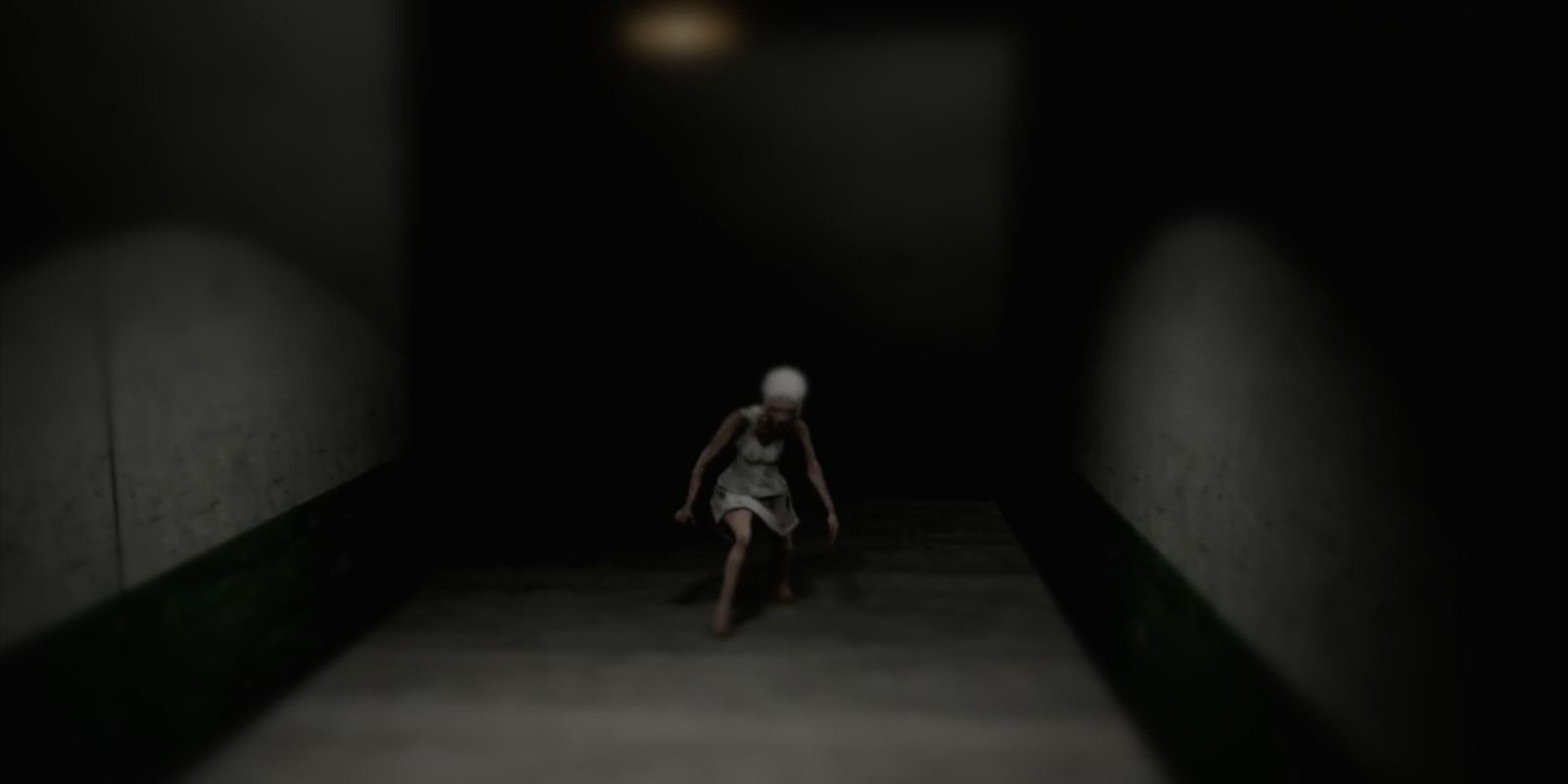 Emily in darkly-lit hallway