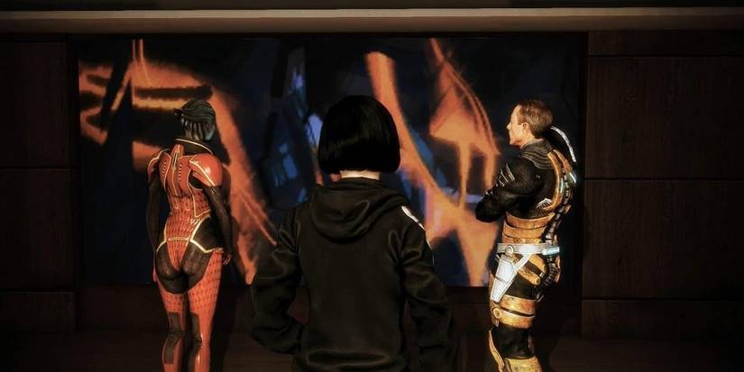 Samara and Zaeed looking at a painting.