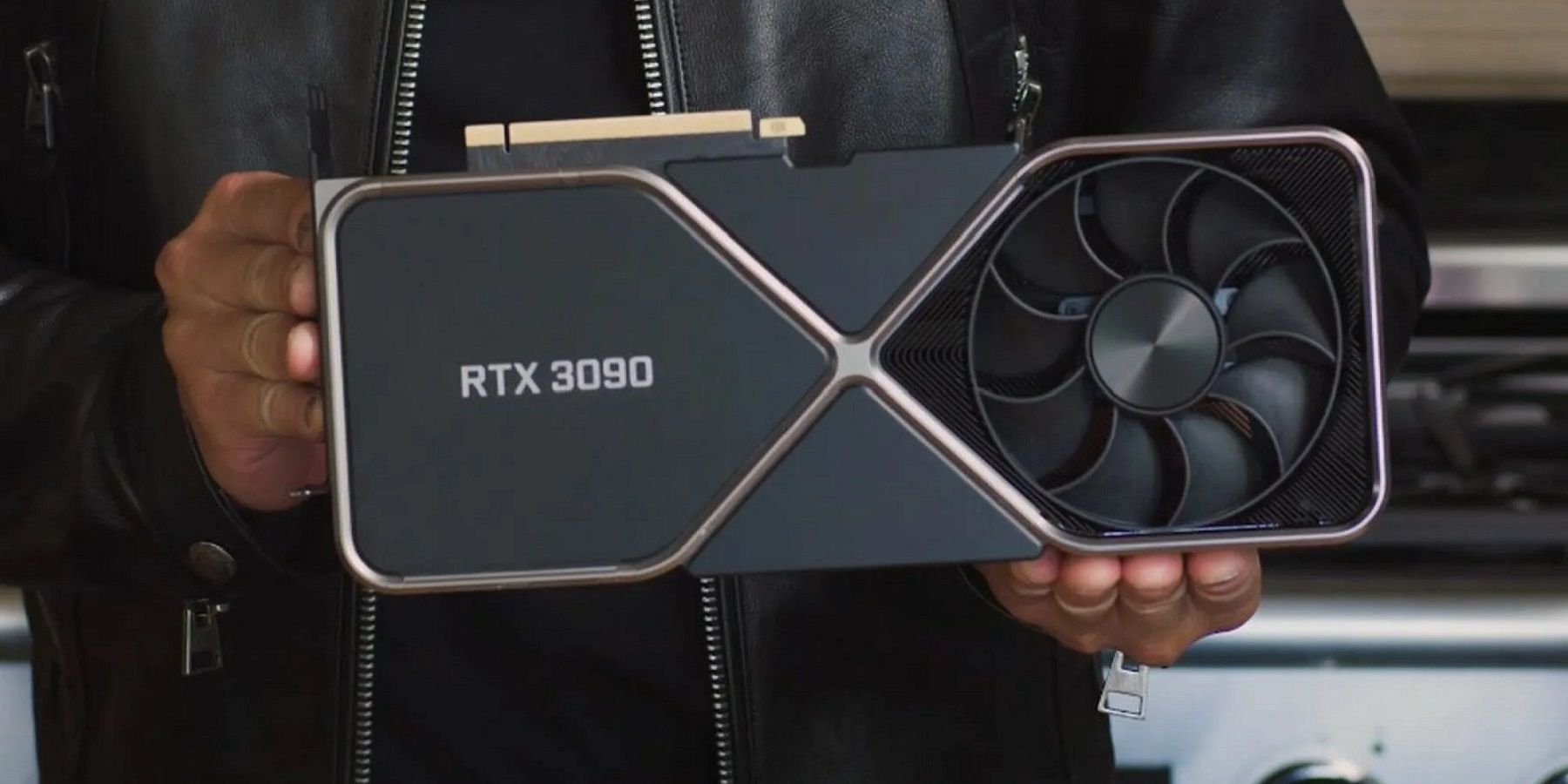 An image of Nvidia CEO's hands holding an RTX 3090 graphics cards.