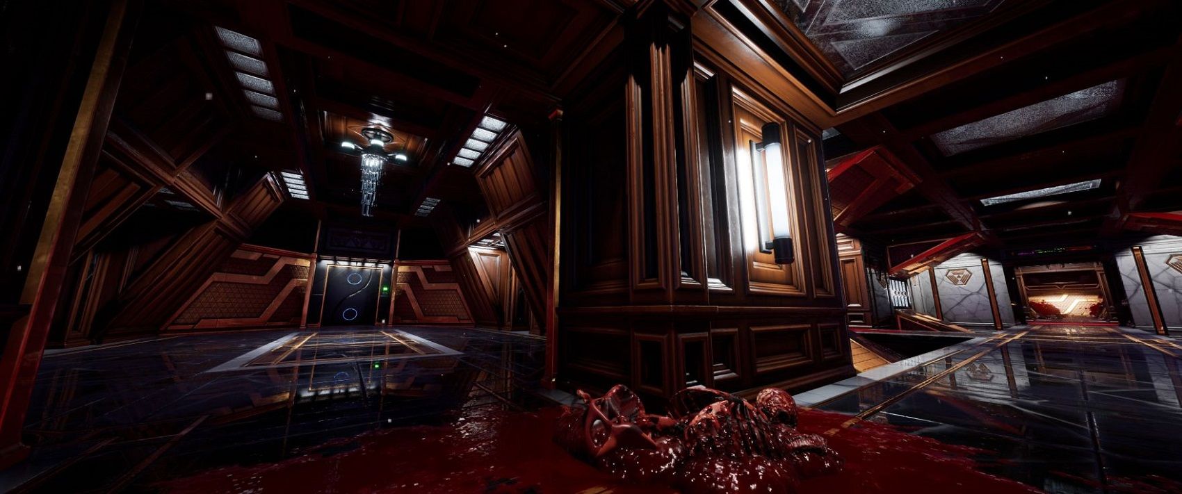 Screenshot from the System Shock remake showing a hallway with a bloodied skeleton in the middle of the floor.