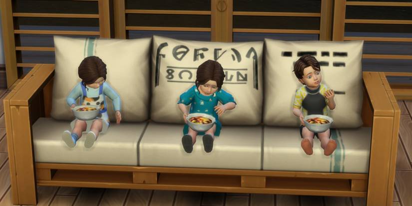 three Toddlers sitting on a couch talking with each other and eating