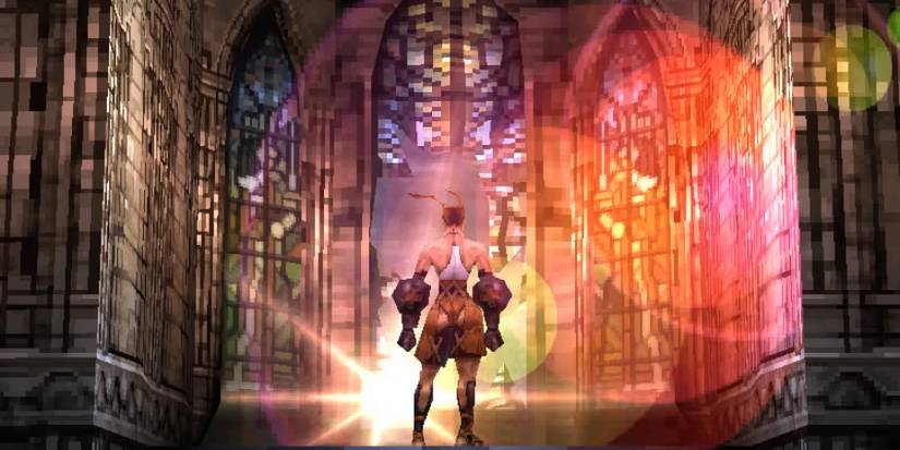 A cutscene showing Ashley Riot approaching a stained glass window in Vagrant Story. Light is shining through the colorful glass.