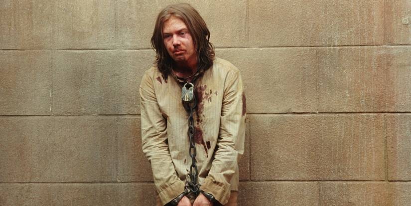 A prisoner chained up in his cell in The Proposition