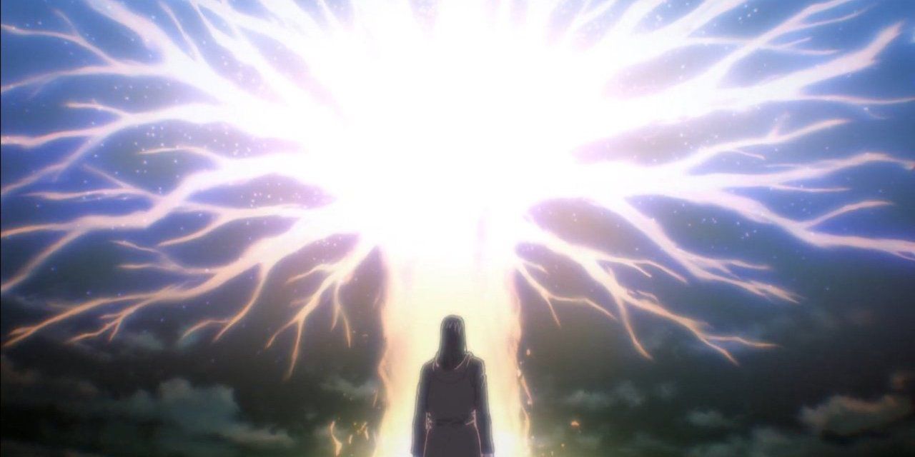 Man standing in front of a huge beam of light with branches