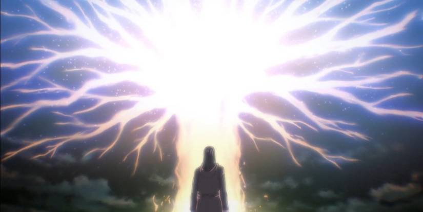 Man standing in front of a huge beam of light with branches