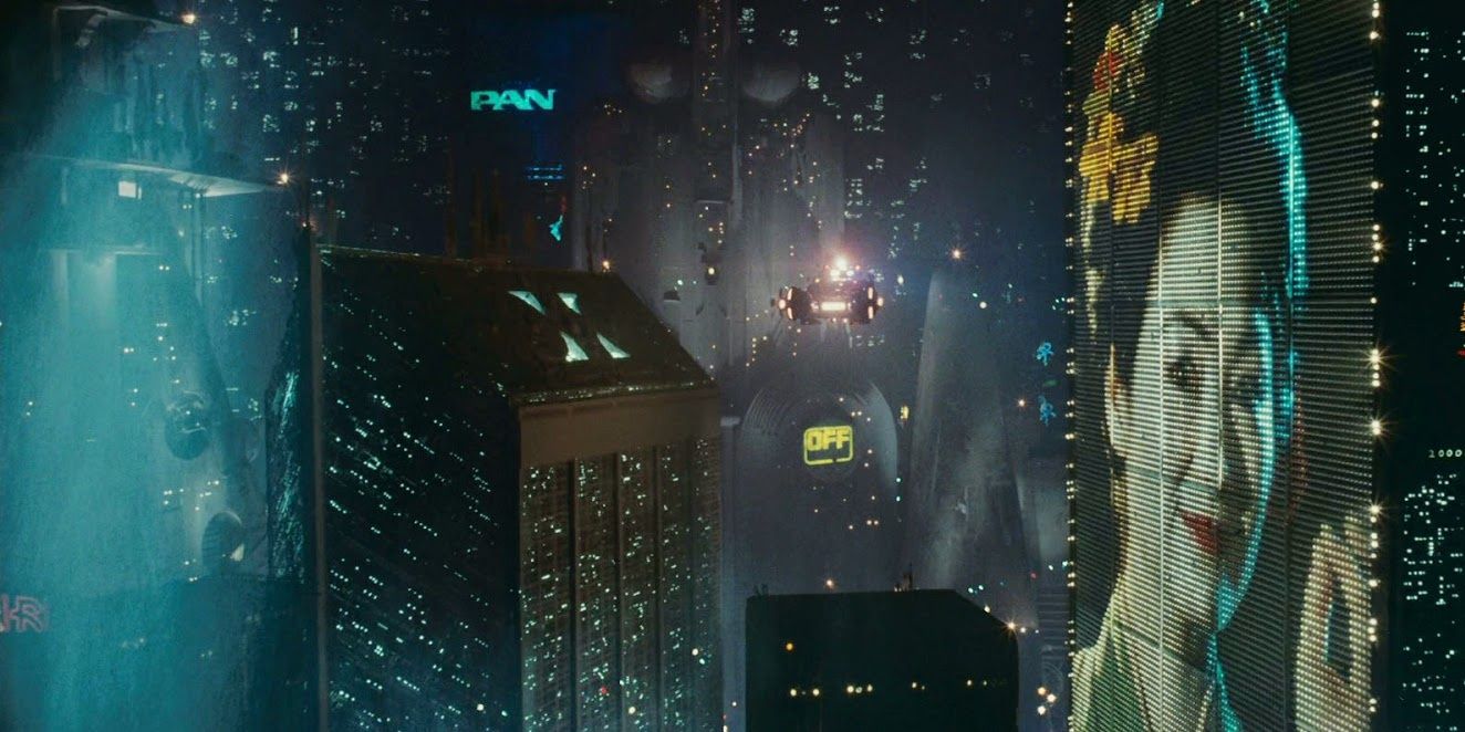 A flying police car with Deckard inside flies through a row of skyscrapers in future Los Angeles, large electronic billboards on the buildings