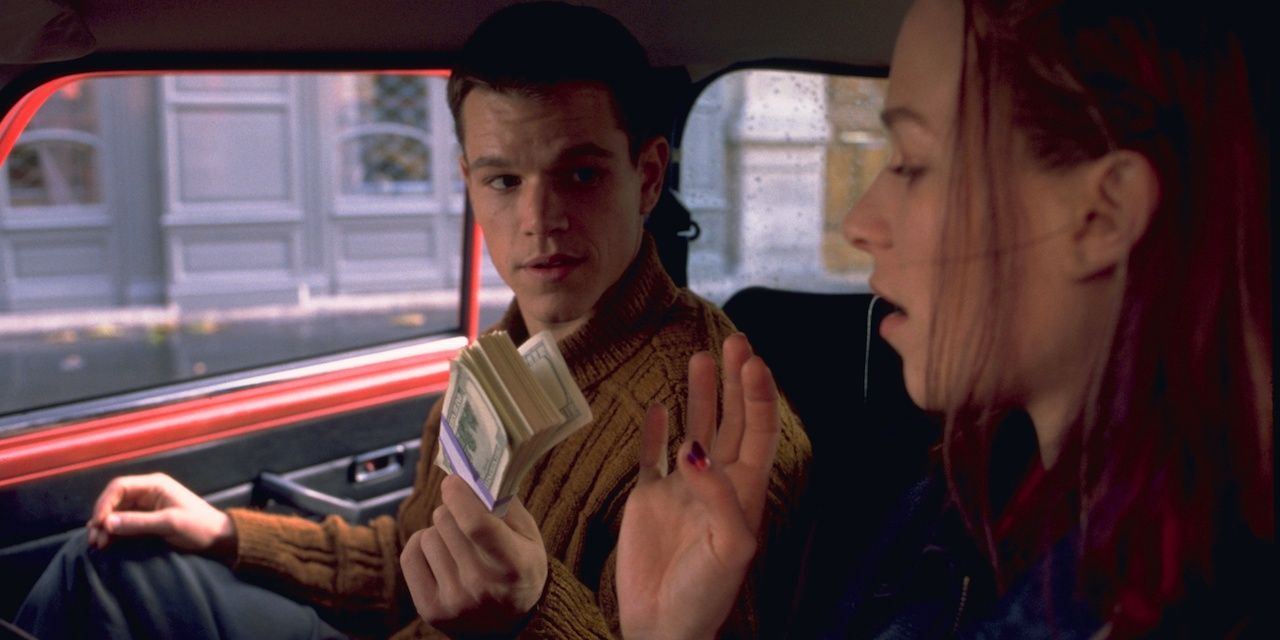 Jason Bourne (Matt Damon) hands a wad of cash to Marie Kreutz inside her car, from the Bourne Identity.