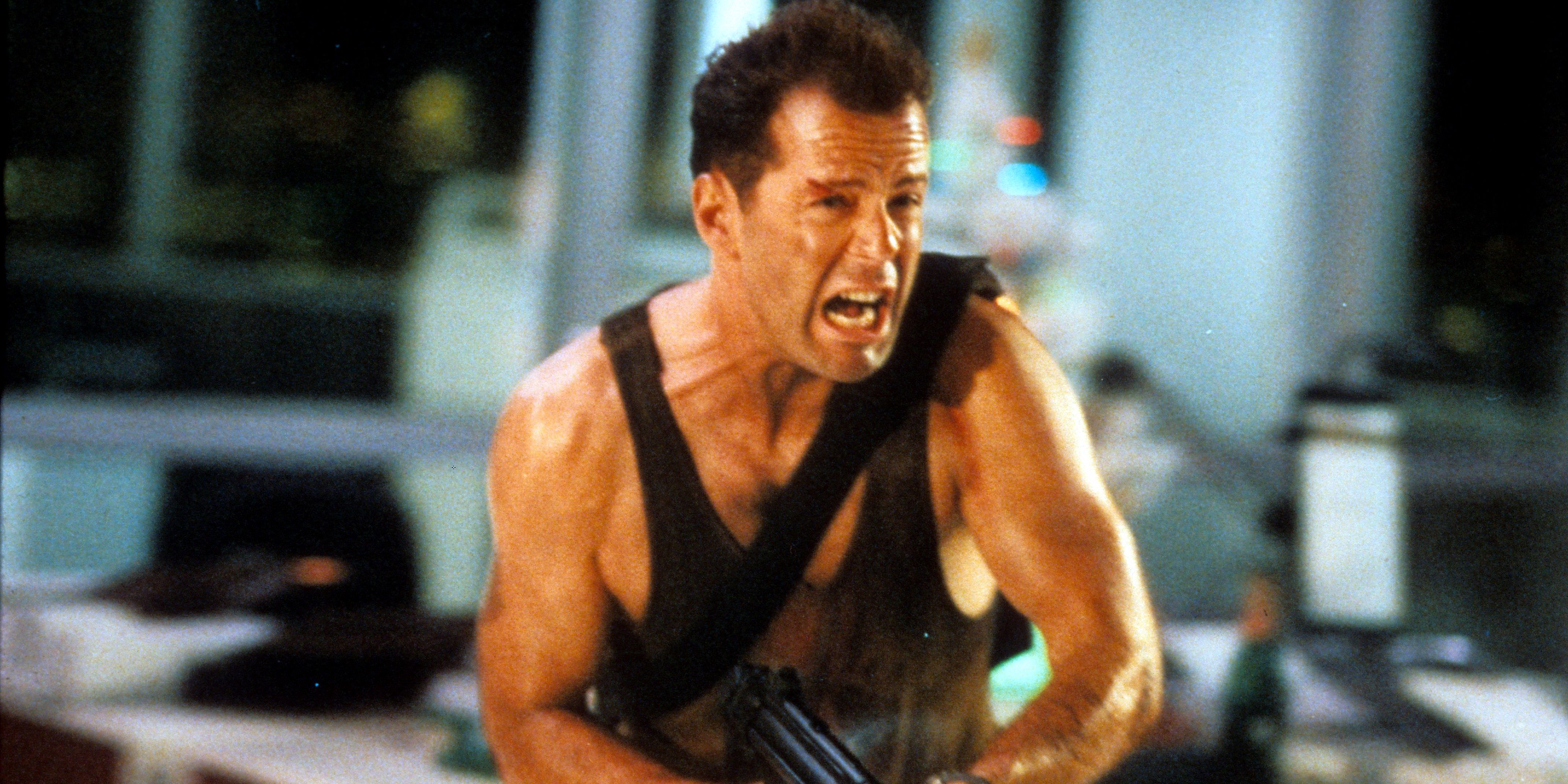 Bruce Willis carrying a machine gun in Die Hard