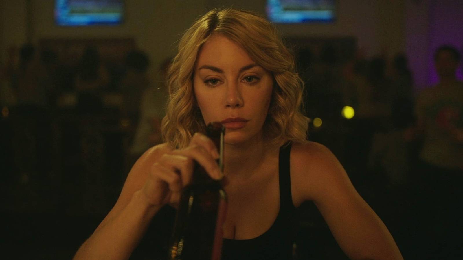 Jennifer Holland as Emilia Harcourt in Peacemaker bar scene