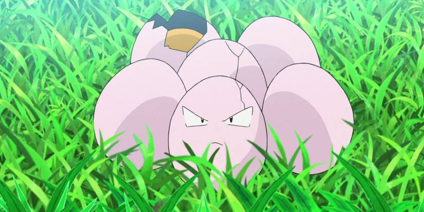 An Exeggcute sitting in the grass in the Pokemon anime