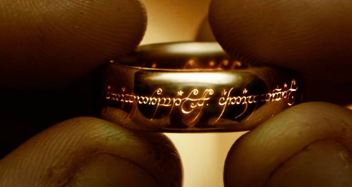 Frodo holding the One Ring as Black Speech appears in Lord of the Rings