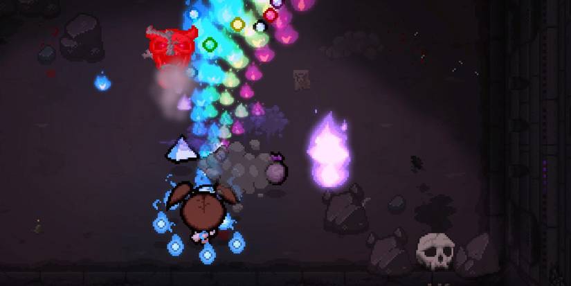 The Binding of Isaac: Repentance. The character Bethany, surrounded by fiery blue wisps, fires a stream of rainbow-colored bullets upward at an enemy.