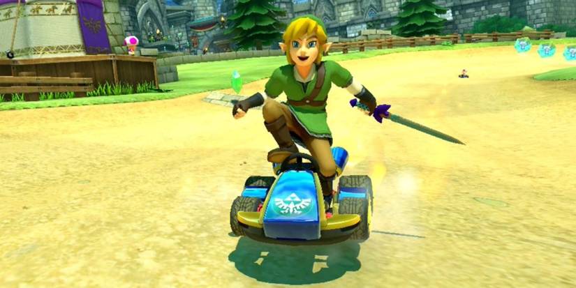 Link smiling, holding the Master Sword, and standing on his kart in Mario Kart 8 Deluxe