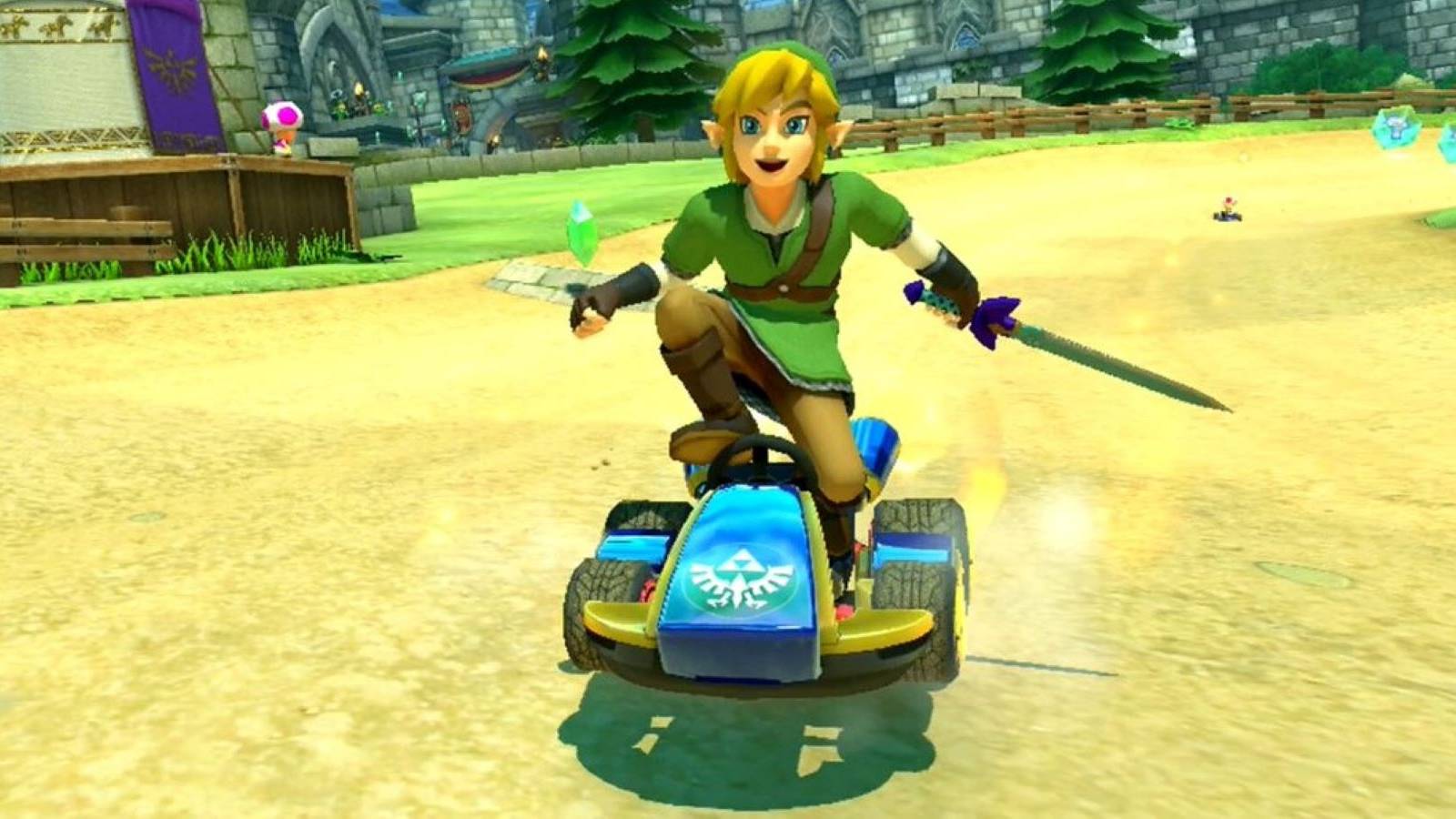 Link smiling, holding the Master Sword, and standing on his kart in Mario Kart 8 Deluxe