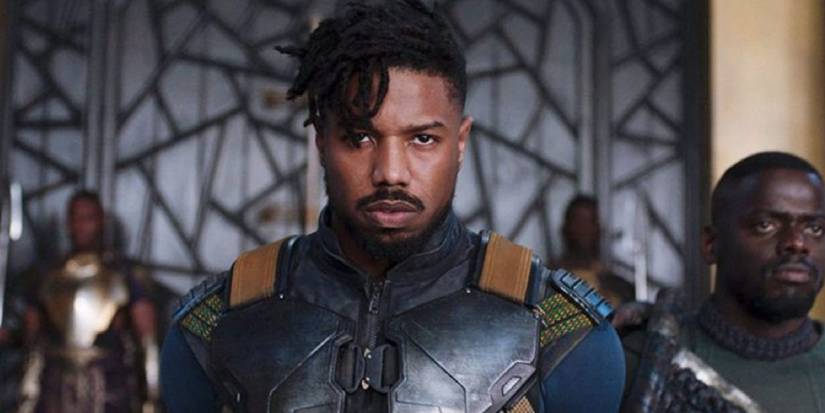 Erik Killmonger in chains standing next to W'Kabi in the Wakandan Throne Room