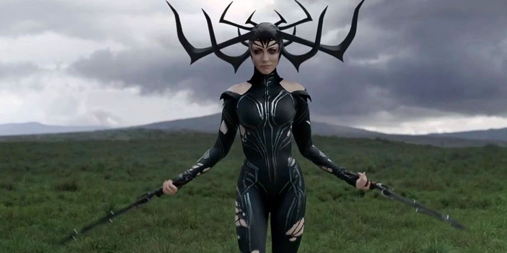 Hela brandishing two swords in a field in Thor: Ragnarok