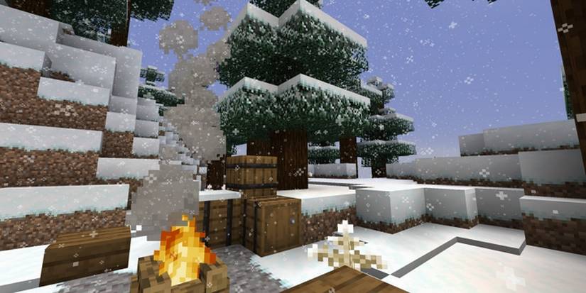 scenic snowy area by snowcapped mountain, tree and campfire in Minecraft