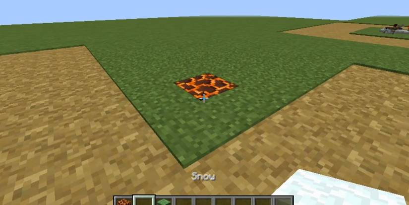 Minecraft snow trap lava block surrounded by grassy field holding snow block