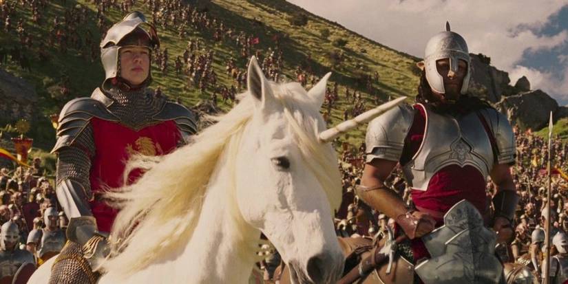 Peter, riding a unicorn, and Oreius the centaur head into battle while wearing a full suit of red armor in the movie Chronicles of Narnia