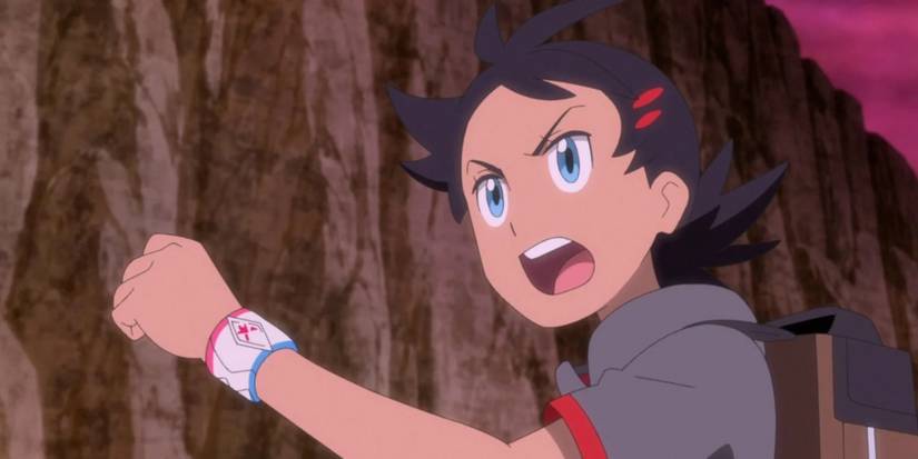 Pokemon anime Goh raising fist during battle in mountain range