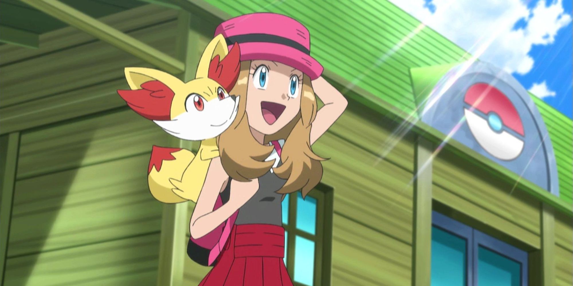 Pokemon anime Serena standing outside Pokemon Center with Fennekin on her back