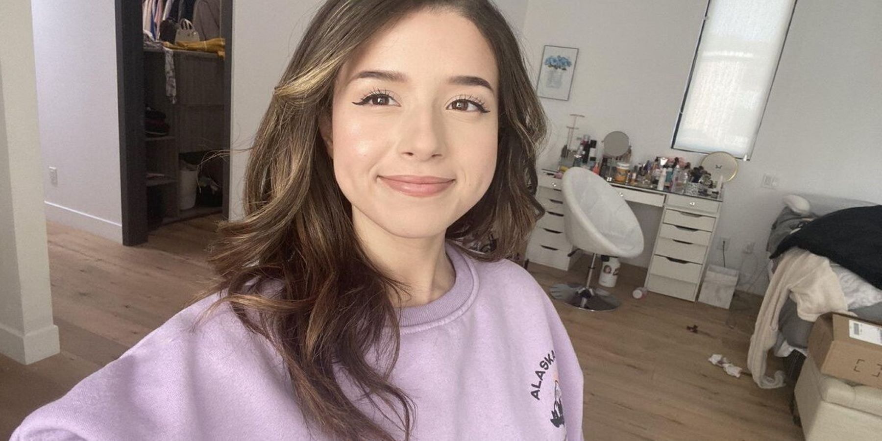 Twitch streamer Pokimane taking a selfie and smiling