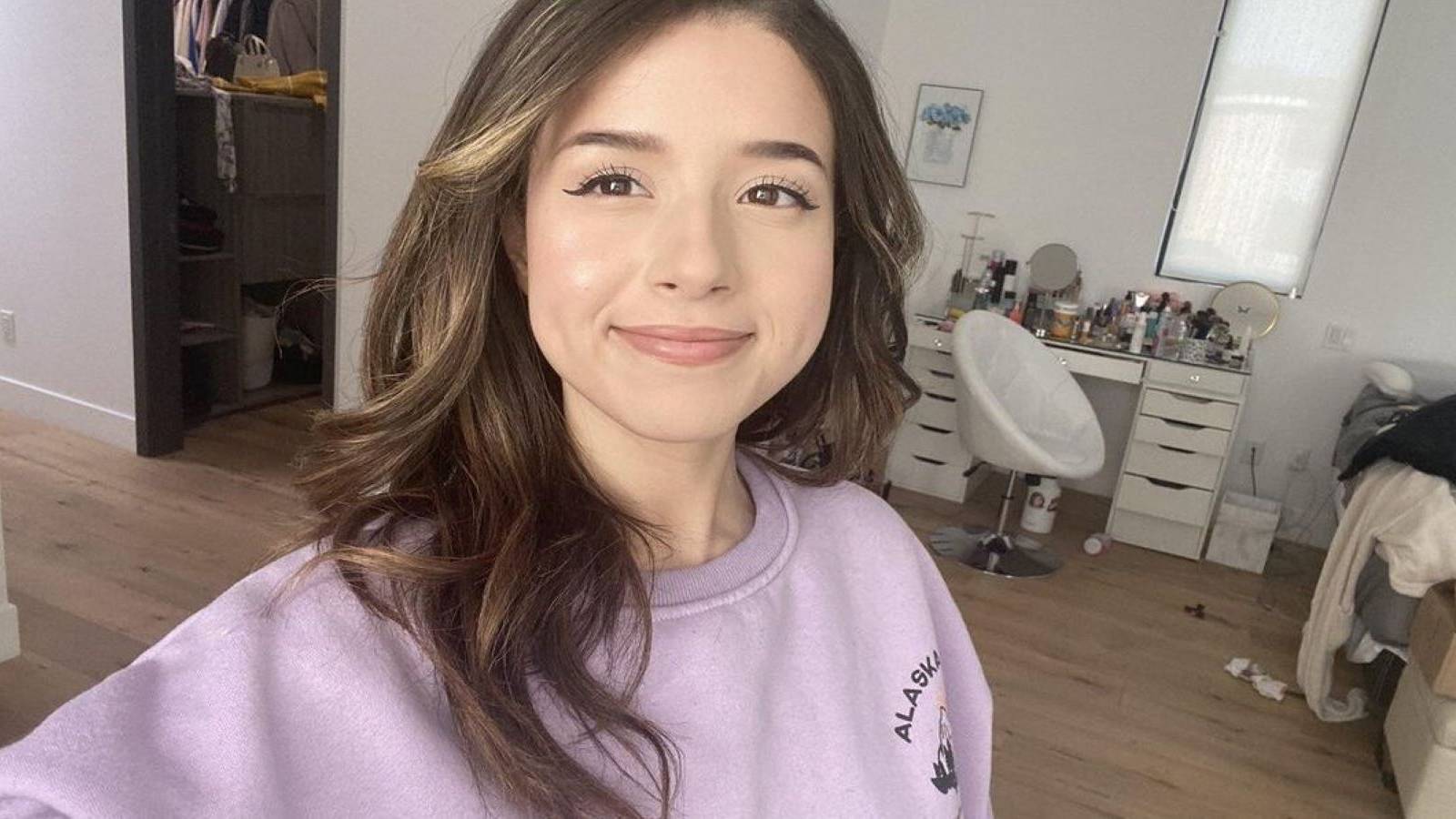 Twitch streamer Pokimane taking a selfie and smiling