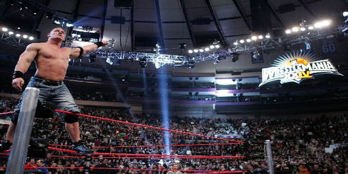 Cena pointing to wrestlemania sign