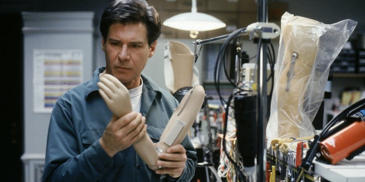 Harrison Ford, playing Dr. Robert Kimble, holds a prosthetic arm in a lab, form the film The Fugitive.