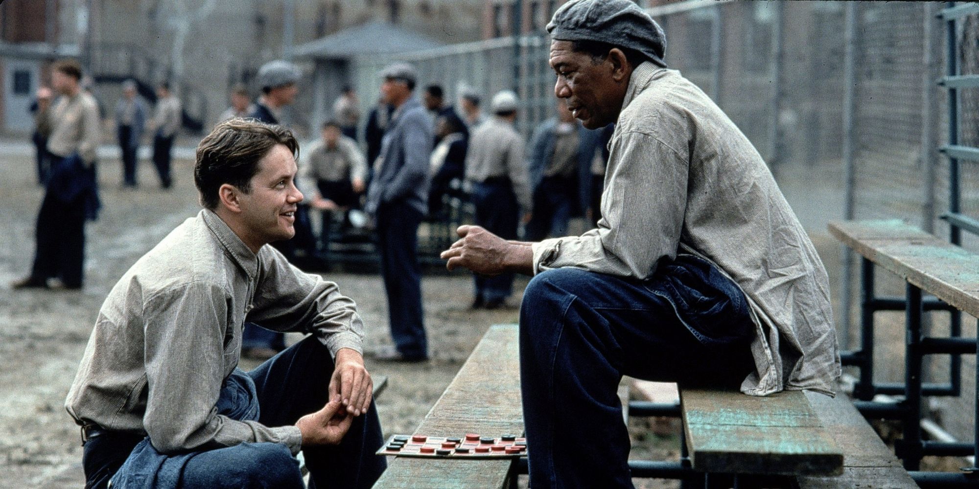 The two main characters from The Shawshank Redemption sitting and talking