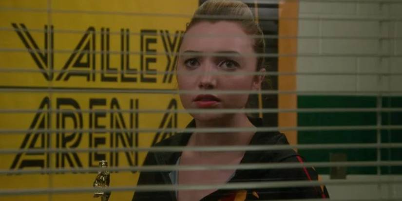 Tory looking through the blinds after the All Valley Tournament in Cobra Kai