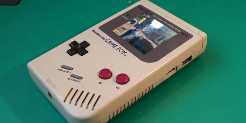 A phot of a Nintendo Game Boy with a screenshot from Grand Theft Auto 5 superimposed onto the screen.