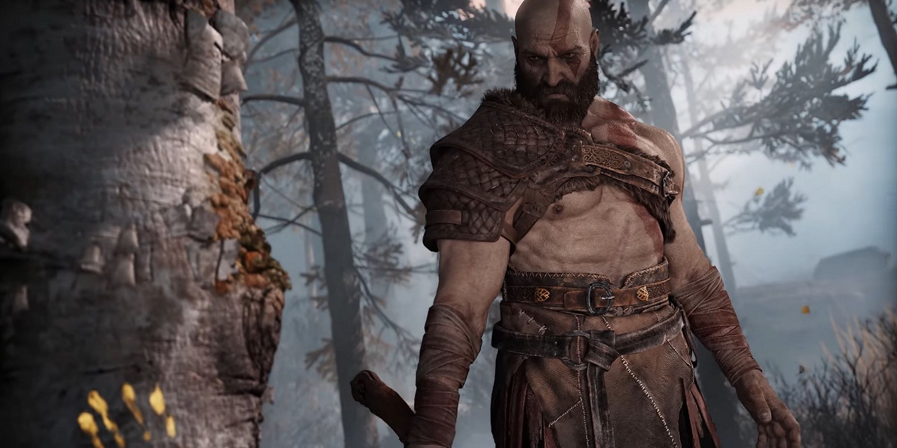 Image from God of War on PC showing Kratos about to chop a tree down.