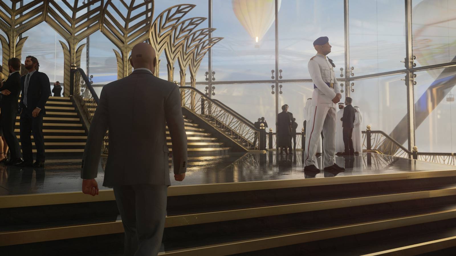 An image from Hitman 3 showing Agent 47 walking up some fancy stairs.